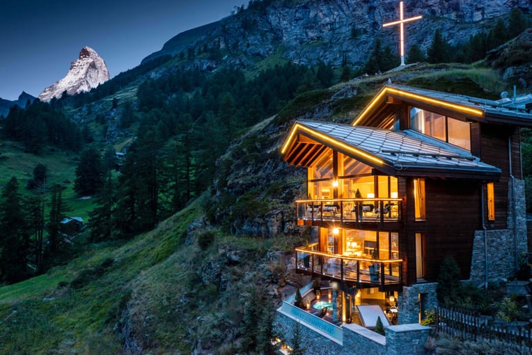 Chalet Zermatt Peak, Švýcarsko – Zermatt | Exclusive Tours Chalet lit up summer evening with  Cross and MH