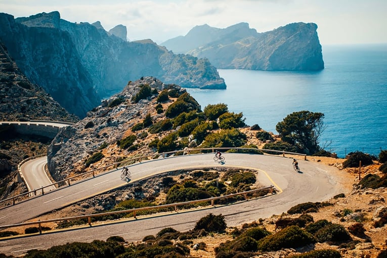 Son Bunyola Hotel cycling-with-cap-de-formentor-in-the-background-mallorca-2-2240x1356-1440x872-q90